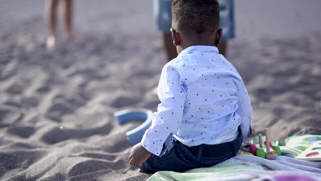 African american family enjoy summer vacation on the beach - Mother, father and child love - Cute toddler looking in camera
