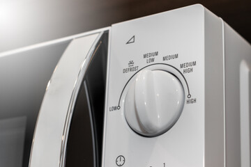 Close-up of control panel of white microwave.