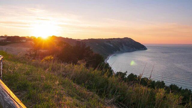 Time lapse: sunset landscape Conero natural park dramatic coast headland rocky cliff adriatic sea beautiful sky colorful horizon, tourism destination Italy