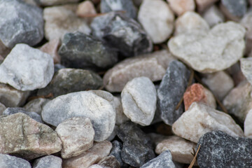 Raw rocks and minerals as natural stones background with crushed and rough material at a rough coast or rocky beach show nuggets and sandstones in harmonic pastel colors as natural mineral background