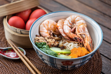 Close-up on serving of birthday longevity noodles with red eggs, a tradition among Chinese during birthday celebrations