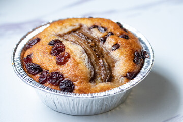Banana cake in a floy cup on a white background.