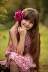 Photo of a beautiful girl with a flower in her hair.