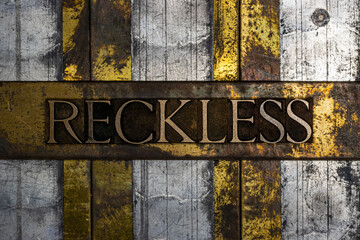 Reckless text on textured grunge copper and vintage gold background