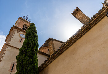Upward view overlooking the bell tower and church of Castelló de Rugat, Valencia (Spain).