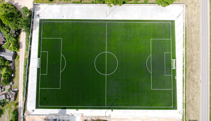 Aerial view of a green soccer field with white paint markings