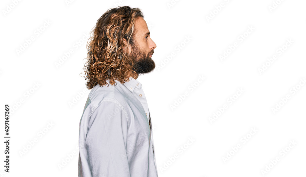 Wall mural handsome man with beard and long hair wearing casual clothes looking to side, relax profile pose wit