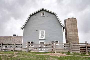 Classic Gray barn and cement silo on a cloudy day © knowlesgallery