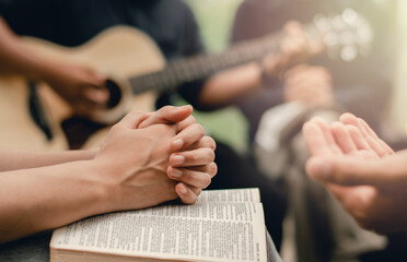 Christian prayer group with bible by playing the guitar to worship God - obrazy, fototapety, plakaty