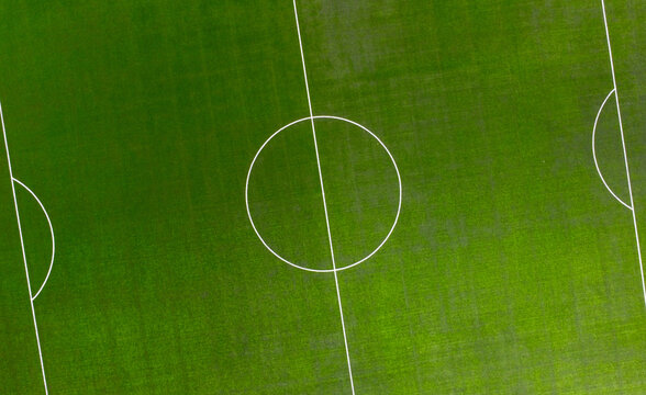 Aerial view of a green soccer field with white paint markings