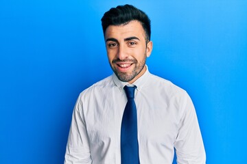Young hispanic man wearing business clothes with a happy and cool smile on face. lucky person.