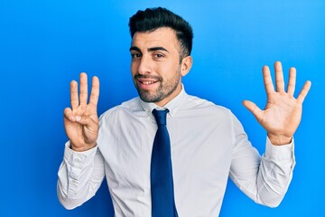 Young hispanic man wearing business clothes showing and pointing up with fingers number eight while smiling confident and happy.
