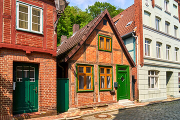 Tiny half-timbered house between two big houses in medieval old town of Lauenburg, Germany