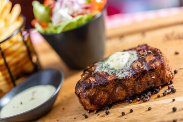 Beef steak meal with salad and french fries in american restaurant