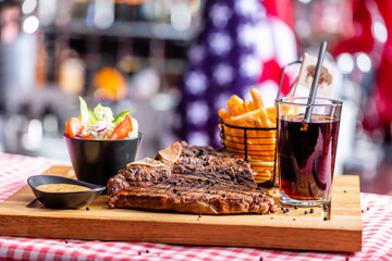 Beef steak dish with salad and french fries in american restaurant