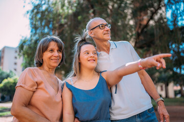 Latina family happy outdoors with daughter with down syndrome