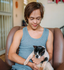 Latin disabled man cuddles a cute cat