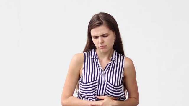 Woman with severe stomach aches with white background.