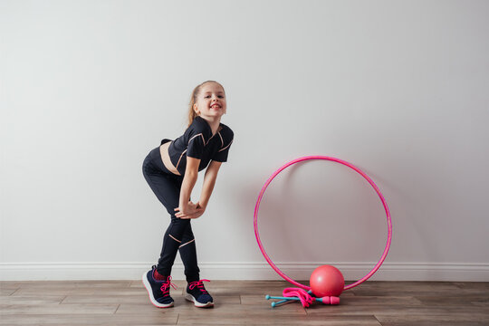 Young Professional Gymnast Girl Posing With Equipment