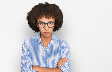 Young hispanic girl wearing business shirt and glasses skeptic and nervous, disapproving expression...