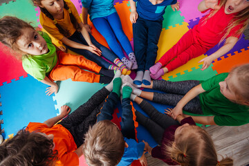 Top view circle of young kids in colorful clothes