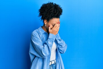 Obraz na płótnie Canvas Young african american girl wearing casual clothes with sad expression covering face with hands while crying. depression concept.