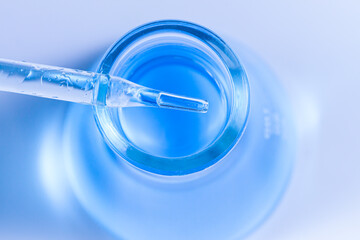blue liquid pipette and bottle see lab images,Genetic research and Biotech science Concept. Human Biology and pharmaceutical technology on laboratory background.