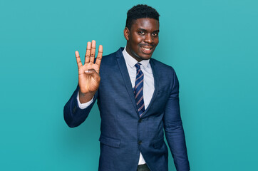 Handsome business black man wearing business suit and tie showing and pointing up with fingers number four while smiling confident and happy.