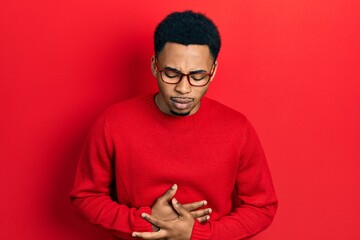 Young african american man wearing casual clothes and glasses with hand on stomach because indigestion, painful illness feeling unwell. ache concept.