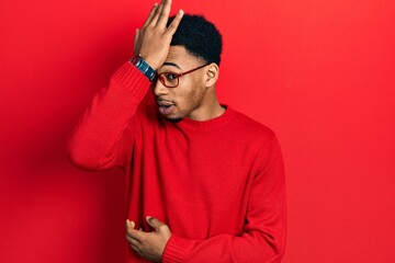 Obraz premium Young african american man wearing casual clothes and glasses surprised with hand on head for mistake, remember error. forgot, bad memory concept.