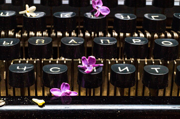 old typewriter with lilac flowers