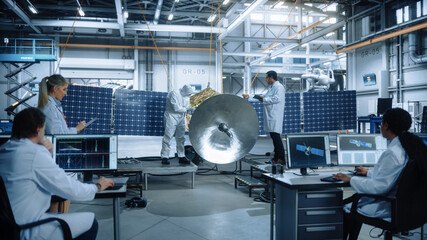 Team of Engineers Working on Satellite Construction. Aerospace Agency Spaceship Manufacturing Factory. Group of Multi-Ethnic Scientists Developing Spacecraft. World Space Exploration Program