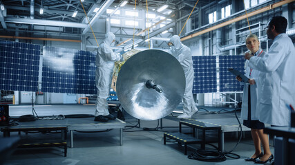 Engineer and Technician in Protective Suits Working on Satellite Construction. Aerospace Agency:...