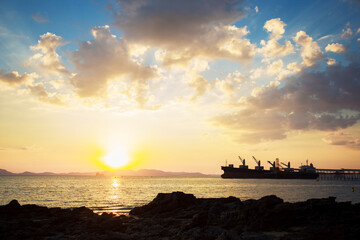 Beautiful twilight on the coast at dusk and a stranded ship