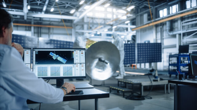 Team of Engineers Working on Satellite Construction. Aerospace Agency International Space Mission: Diverse Group of Scientists Developing Spacecraft, Calculate Orbital Trajectory Tracking on Computer