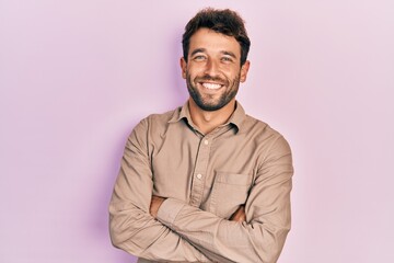 Handsome man with beard wearing casual shirt happy face smiling with crossed arms looking at the camera. positive person.