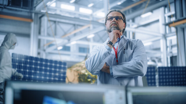 Portrait of Mature Male Engineer Confident and Focused Thinking, working at Aerospace Satellite Manufacturing Facility. Top World Scientists Doing Science and Technology Research in Space Program