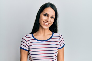 Fototapeta premium Young hispanic woman wearing casual clothes with a happy and cool smile on face. lucky person.