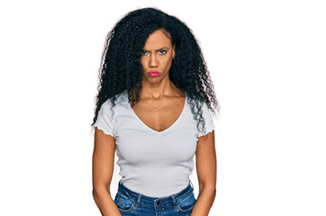 Middle age african american woman wearing casual white t shirt depressed and worry for distress, crying angry and afraid. sad expression.