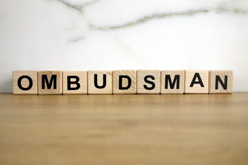 Ombudsman word from wooden blocks on desk
