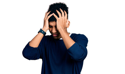Young african american man wearing casual clothes suffering from headache desperate and stressed because pain and migraine. hands on head.