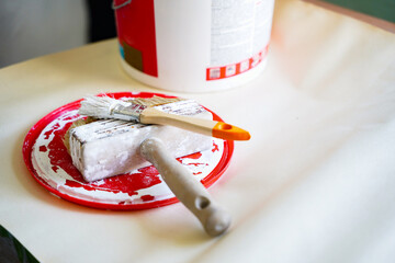 A set of equipment for apartment repair, painting and design. Brush, paint can on the floor.