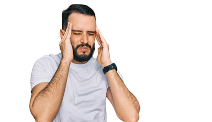 Fototapeta premium Young man with beard wearing casual white t shirt with hand on head, headache because stress. suffering migraine.