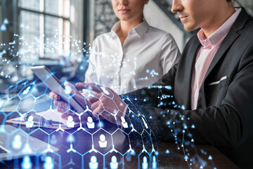 Businessman and businesswoman in formal wear working together looking for new employees to hire for international business consulting. HR, social media icons over modern panoramic office background