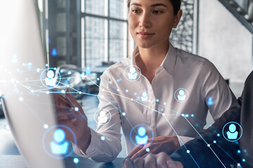 Businessman and businesswoman in formal wear working together looking for new employees to hire for international business consulting. HR, social media icons over modern panoramic office background