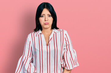 Fototapeta premium Young hispanic girl wearing casual clothes depressed and worry for distress, crying angry and afraid. sad expression.