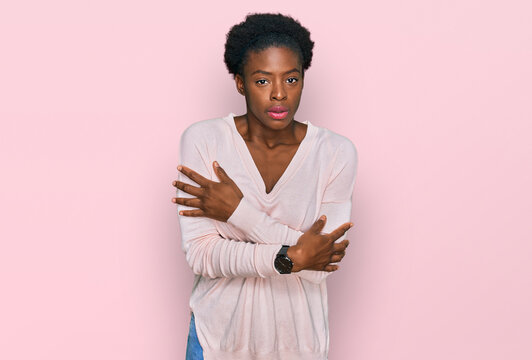 Young african american girl wearing casual clothes shaking and freezing for winter cold with sad and shock expression on face