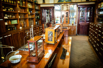 Old pharmacy cabinet with retro bottles and shelfs with medicaments