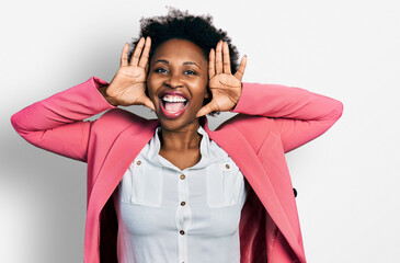 African american woman with afro hair wearing business jacket smiling cheerful playing peek a boo with hands showing face. surprised and exited