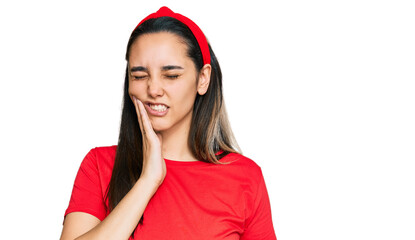 Young hispanic woman wearing casual clothes touching mouth with hand with painful expression because of toothache or dental illness on teeth. dentist